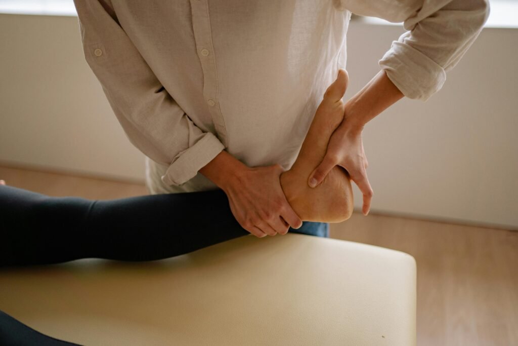 Close-up of a massage therapist giving a relaxing foot treatment indoors.